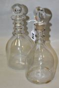 TWO GEORGE III CLEAR GLASS MALLET SHAPED DECANTERS, with target stoppers and triple ring necks,