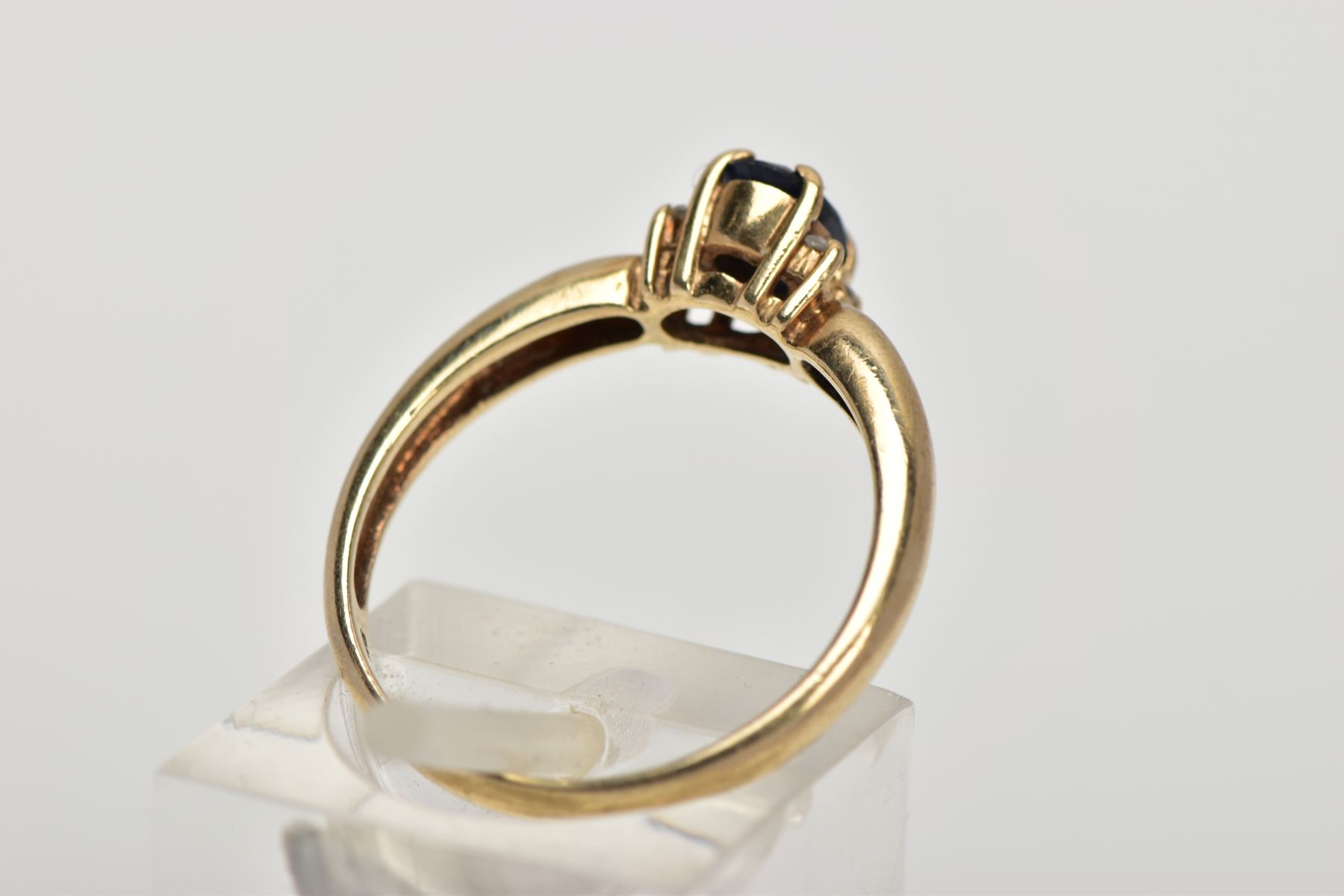 A 9CT GOLD SAPPHIRE AND DIAMOND RING, centring on an oval cut blue sapphire, flanked with four round - Image 3 of 4