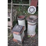THREE VINTAGE CHIMNEY POTS two circular in profile 70cm and 64cm in height and a smaller square