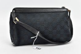 A SMALL BLACK GUCCI BAG, the monogram canvas with brass fittings and zip closure, inner label