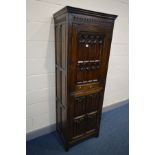 A GOOD QUALITY REPRODUCTION OAK TWO DOOR CUPBOARD, ecclesiastical and linenfold panelled doors