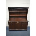 A STAG MINSTREL DRESSER, width 142cm x depth 46cm x height 171cm