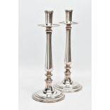 A PAIR OF PLAIN DESIGNED STAINLESS-STEEL CANDLESTICKS, signed to the base 'GTS, Sambonet, Italy'