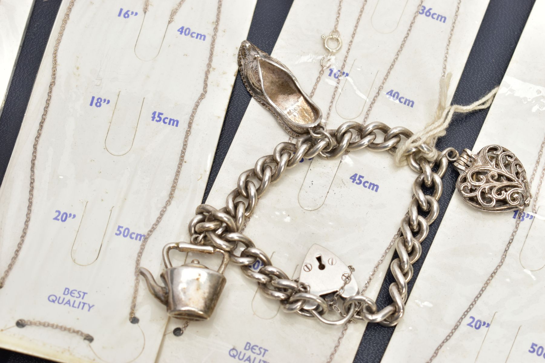 A SELECTION OF PACKAGED CHAINS, FLAT HERINGBONE CHAIN AND A CHARM BRACELET, the bracelet with four - Image 4 of 5