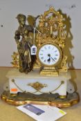 A MID/LATE 19TH CENTURY GILT METAL AND ALABASTER FIGURAL MANTEL CLOCK, the drum shaped clock with