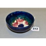 A MOORCROFT POTTERY FOOTED BOWL, decorated with an Anemone flower on a blue/green ground, bears