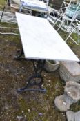 A CAST IRON TABLE, with a later marble top, marked to both legs 'Geo Reid, Leeds' length 122cm x