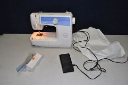 A BROTHER LS2125 SEWING MACHINE with foot pedal/ power cable, a soft cover and a small tray of