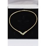 AN EMERALD AND DIAMOND COLLAR NECKLACE, the V-shape central panel channel set with a central line of
