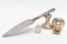 A PAIR OF 1930'S SILVER DWARF CANDESTICKS, A SILVER HANDLED CAKE SLICE AND A SILVER PENDANT, the