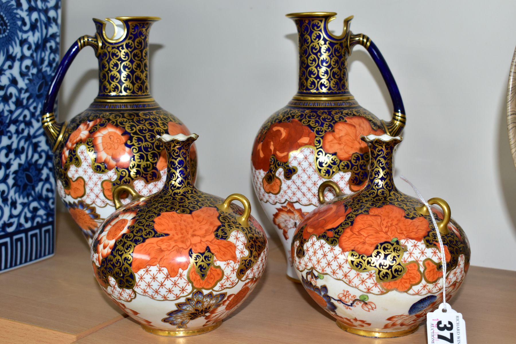 A PAIR OF ROYAL CROWN DERBY IMARI 2444 PATTERN EWERS AND A PAIR OF SQUAT BULBOUS TWIN HANDLED