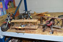 THREE WOODEN AND METAL AIRCRAFT AND TWO METAL MODEL MOTORCYCLES, the aircraft fitted to be displayed