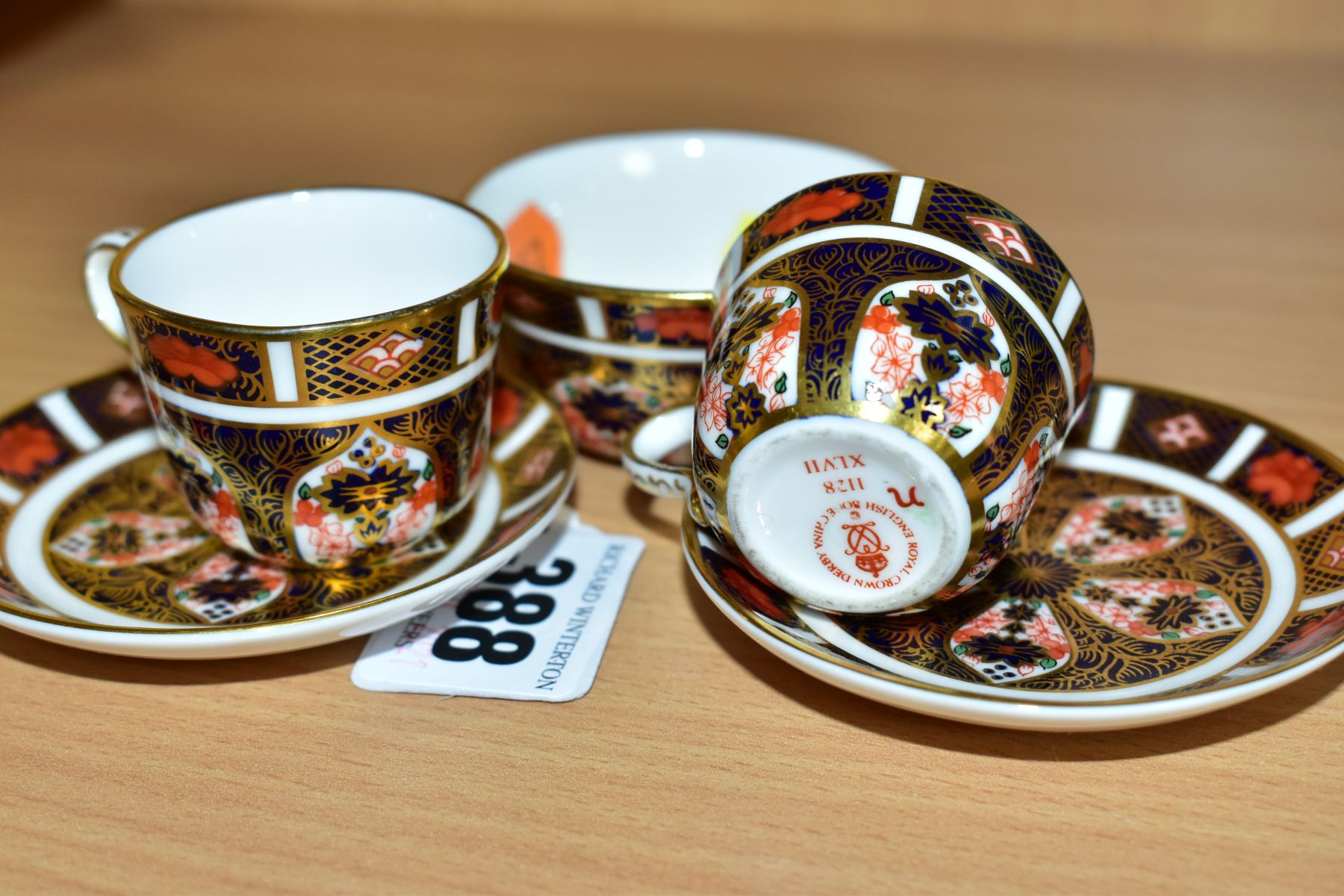 ROYAL CROWN DERBY MINIATURE TEAWARES, '1128' pattern, comprising of two tea cups both XLVII, one - Image 3 of 4