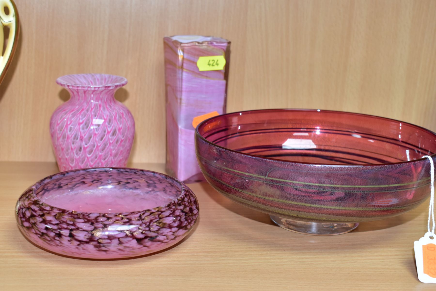 AN ALISTAIR MALCOLM STUDIO GLASS FOOTED BOWL AND THREE OTHER PIECES OF PINK RED GLASSWARE, the
