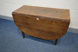 A GEORGIAN OAK OVAL GATE LEG TABLE, on square block legs, brass caps and casters, width 43cm x