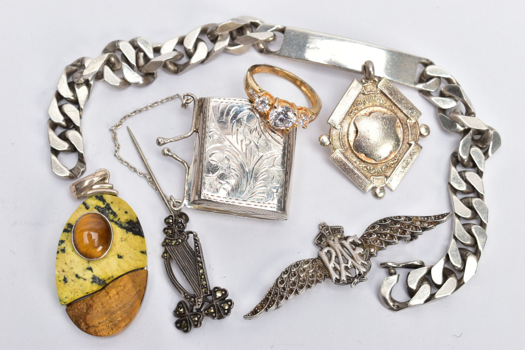 SEVEN ITEMS OF SILVER AND WHITE METAL JEWELLERY, to include a miniature hinged purse, an RAF brooch,