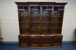 AN EARLY TO MID 20TH CENTURY OAK BREAKFRONT BOOKCASE, four door astragal glazed top section, above