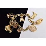 A 9CT CHARM BRACELET, with eight charms and locket, approximate weight 26.8 grams