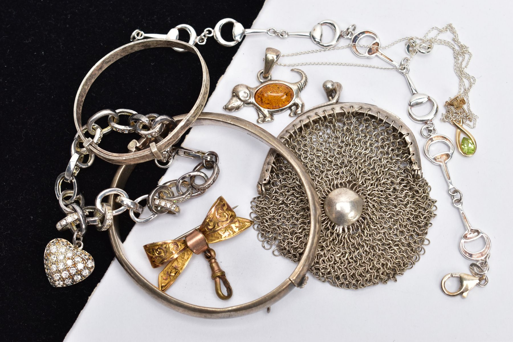 A SELECTION OF JEWELLERY, to include a horse bit bracelet, a child's bangle, a hinged bangle, a