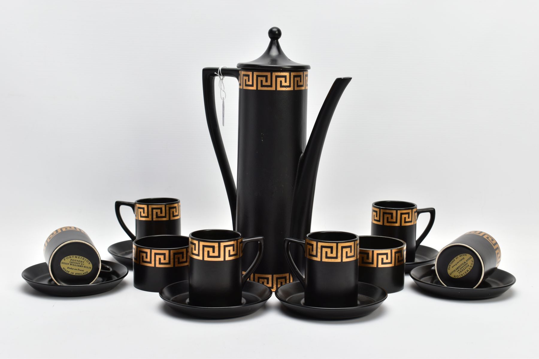 A PORTMEIRION COFFEE SET by Susan Williams-Ellis with gilt Greek key border decoration, on a black