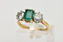AN 18CT GOLD THREE STONE EMERALD AND DIAMOND RING, an emerald cut emerald measuring approximately