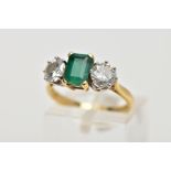 AN 18CT GOLD THREE STONE EMERALD AND DIAMOND RING, an emerald cut emerald measuring approximately