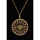 AN EARLY 20TH CENTURY PERIDOT AND SEEDPEARL CIRCULAR BROOCH PENDANT, open work twist wirework