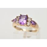 A 9CT GOLD GEM RING, designed as a central rectangular amethyst flanked by two circular colourless