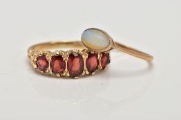 TWO RINGS TO INCLUDE A GARNET HALF HOOP AND A SINGLE STONE OPAL RING. A modern five stone
