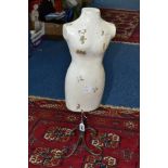 A TABLE TOP MANNEQUIN ON A WROUGHT IRON STAND, the fibreglass mannequin painted white, height 62cm