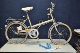 A VINTAGE RALEIGH STOWAWAY FOLDING BIKE with 3 speed Sturmey Archer gears, rear rack, pump and