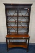 A LATE 19TH CENTURY ASTRAGAL GLAZED TWO DOOR BOOKCASE, blind fretwork decoration, three adjustable