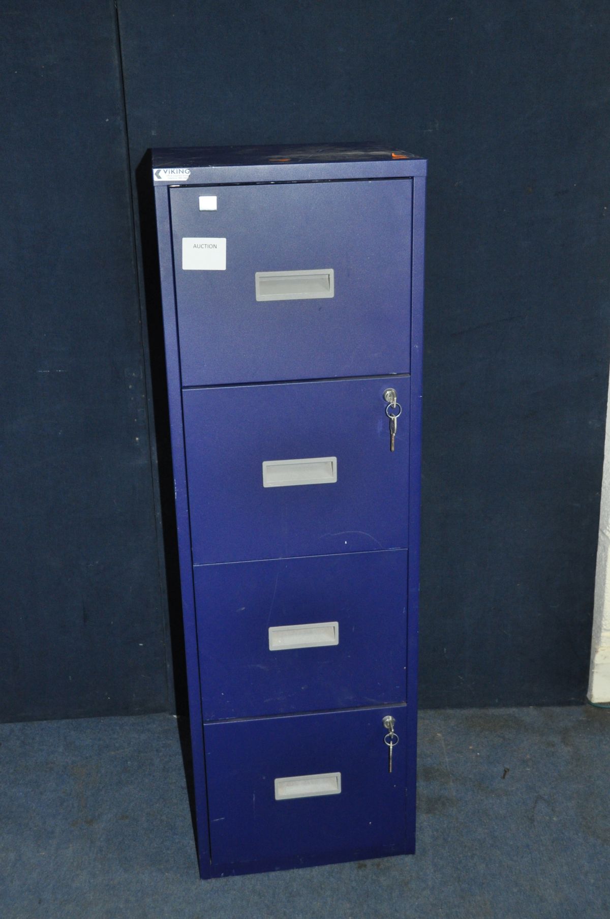 A MODERN METAL FOUR DRAWER FILING CABINET with two keys for each of the two locking drawers,