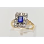 A GOLD EARLY TWENTIETH CENTURY SAPPHIRE AND DIAMOND RECTANGULAR CLUSTER RING, a step cut sapphire