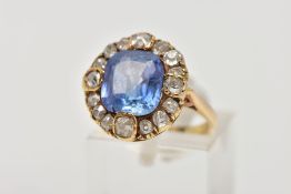 A GOLD VICTORIAN DIAMOND AND SAPPHIRE CLUSTER RING, a large cushion cut pale blueish purple sapphire