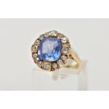 A GOLD VICTORIAN DIAMOND AND SAPPHIRE CLUSTER RING, a large cushion cut pale blueish purple sapphire