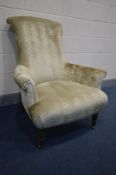 A CHAMPAGNE UPHOLSTERED AMRCHAIR, width 86cm