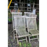 A SET OF FOUR SLATTED HARDWOOD FOLDING GARDEN CHAIRS (one with damaged leg joint)