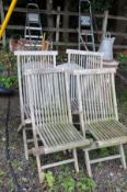 A SET OF FOUR SLATTED HARDWOOD FOLDING GARDEN CHAIRS (one with damaged leg joint)