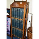 AN EARLY 20TH CENTURY OAK FOUR TIER OPEN BOOKSHELF CONTAINING AN EIGHTEEN VOLUME CHARLES DICKENS