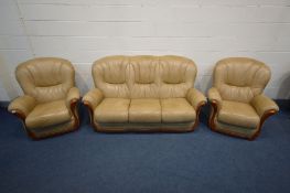 A LIGHT BROWN FAUX LEATHER THREE PIECE SUITE comprising a three seat settee, inner width 140cm and a