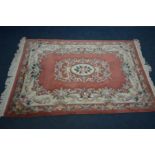 A WOOLLEN SALMON PINK AND CREAM CHINESE RUG, 190cm x 124cm