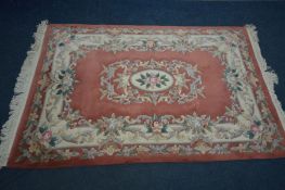 A WOOLLEN SALMON PINK AND CREAM CHINESE RUG, 190cm x 124cm