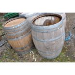 A PAIR OF MODERN OAK BARRELS with galvanised banding height 88cm and 60cm diameter at top and bottom