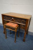 A CARVED OAK SECRETARY DESK, with a hinged top, foliate carved front, on barley twist legs, width