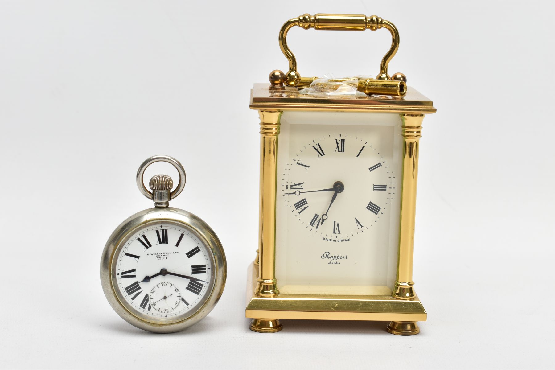 A BRASS CARRIAGE CLOCK AND A MILITARY POCKET WATCH, a white enamel face with black Roman numerals,