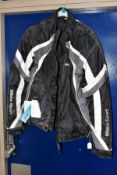 A MILANO SPORT MOTORCYCLE JACKET with tags but needs cleaning and has a hole to the lining,