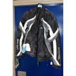 A MILANO SPORT MOTORCYCLE JACKET with tags but needs cleaning and has a hole to the lining,