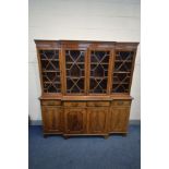 A MAHOGANY BREAKFRONT BOOKCASE, four door glazed top section, four drawers and four cupboard