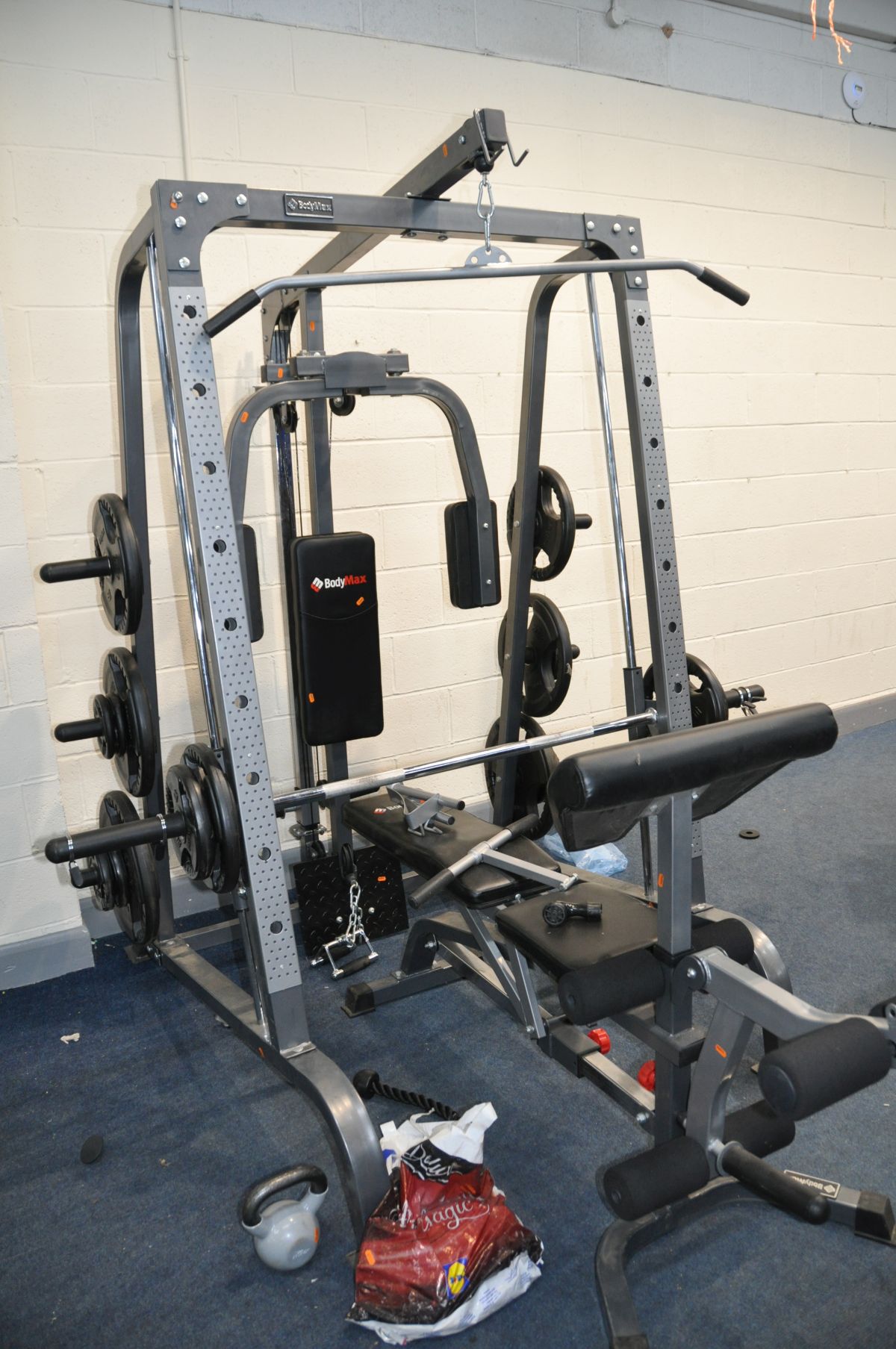 A BODYMAX CF380 SMITH MACHINE MULTI GYM with eighteen weight in pairs from 25kg to 2.5kgs and thirty